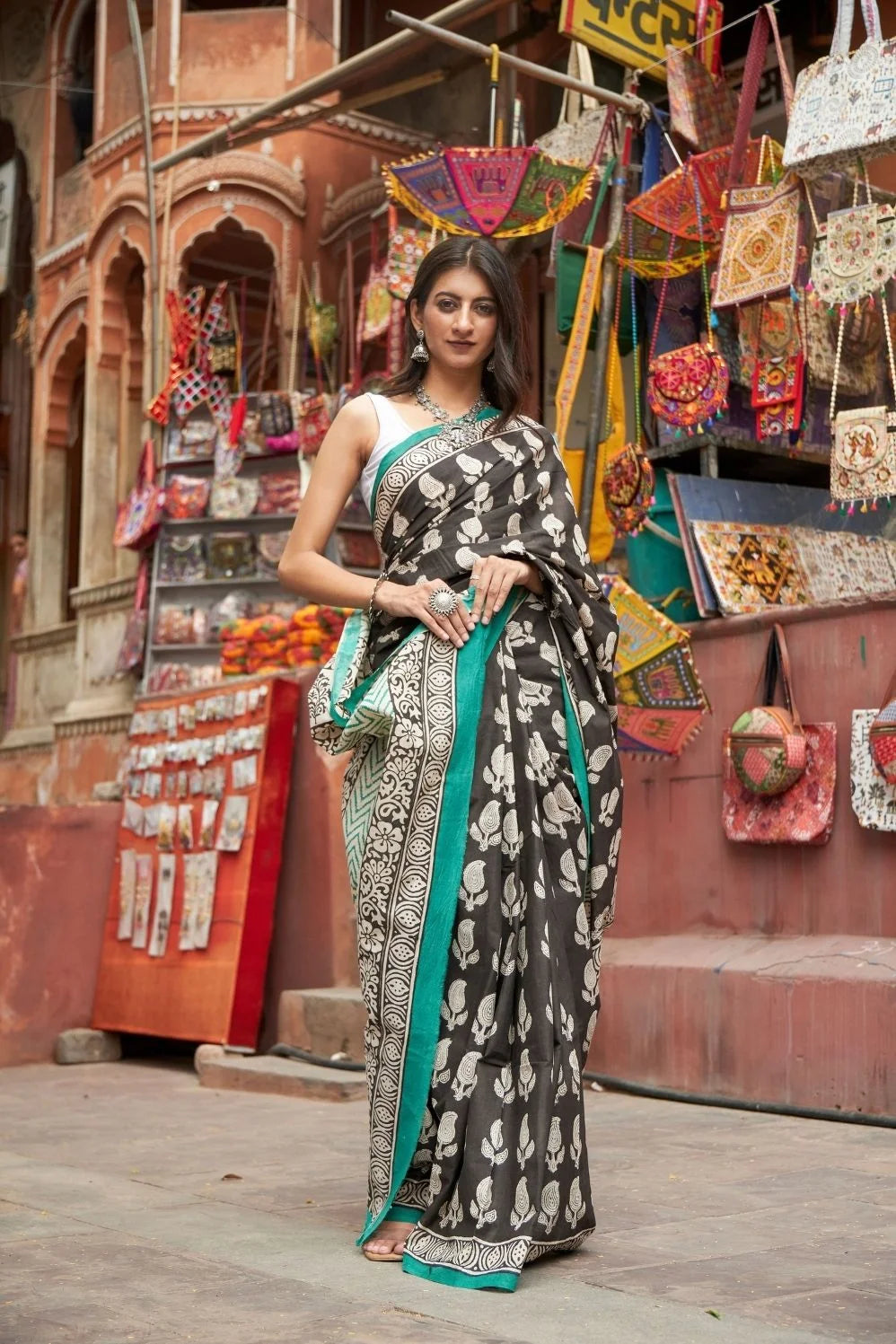 Black mulmul cotton saree with elegant handcrafted motifs.