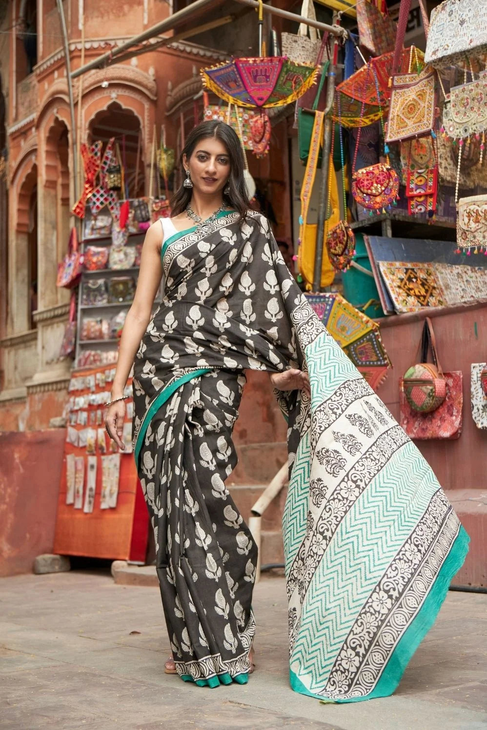 Black mulmul cotton saree with elegant handcrafted motifs.