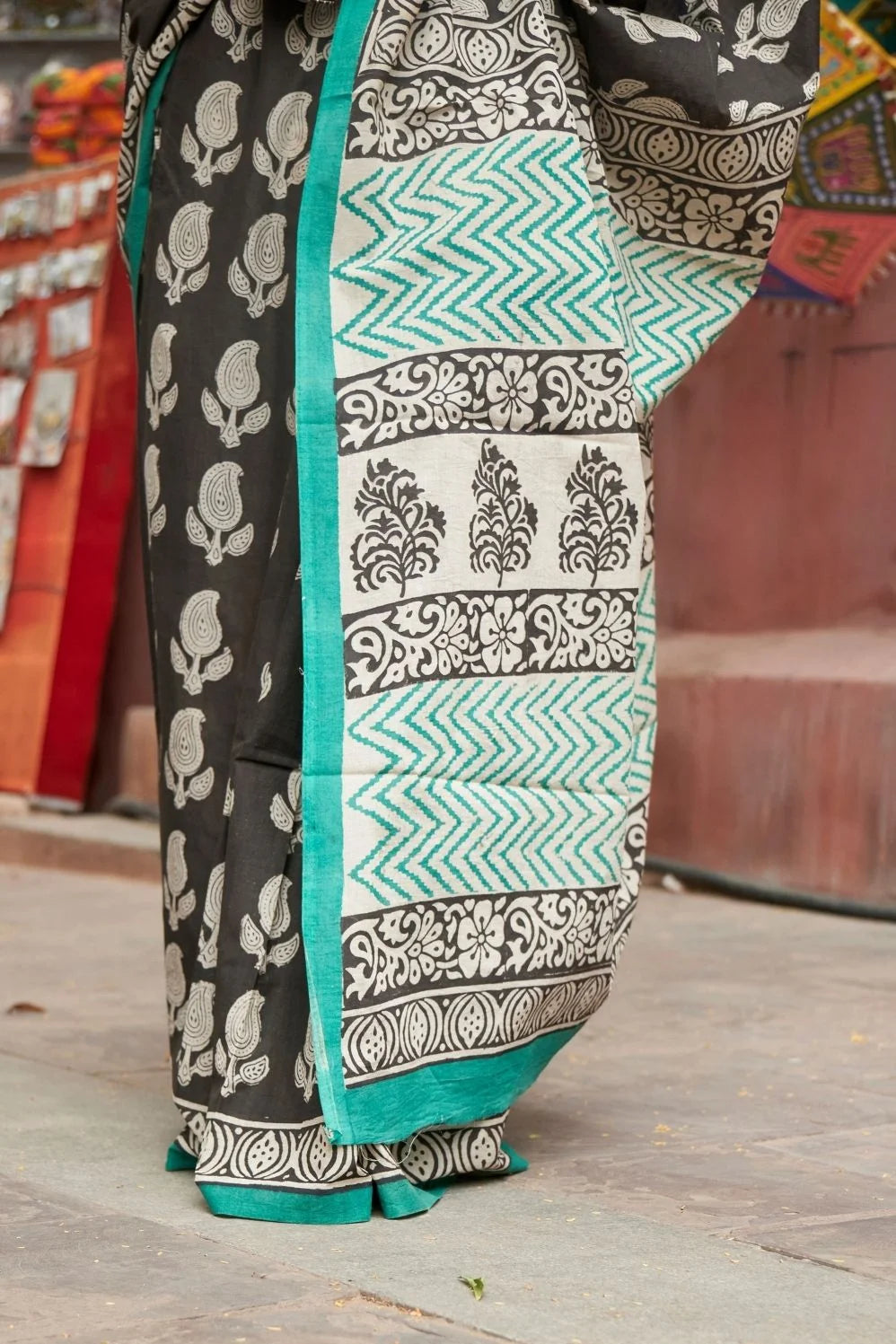Black mulmul cotton saree with elegant handcrafted motifs.