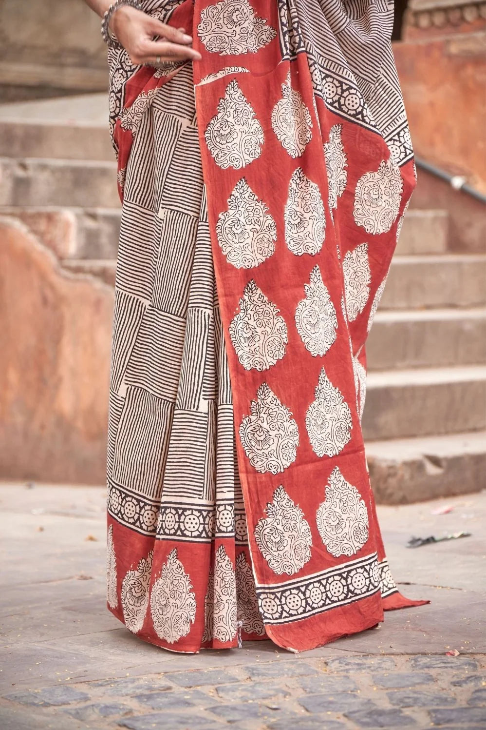 Black mulmul cotton saree with lined block print design.