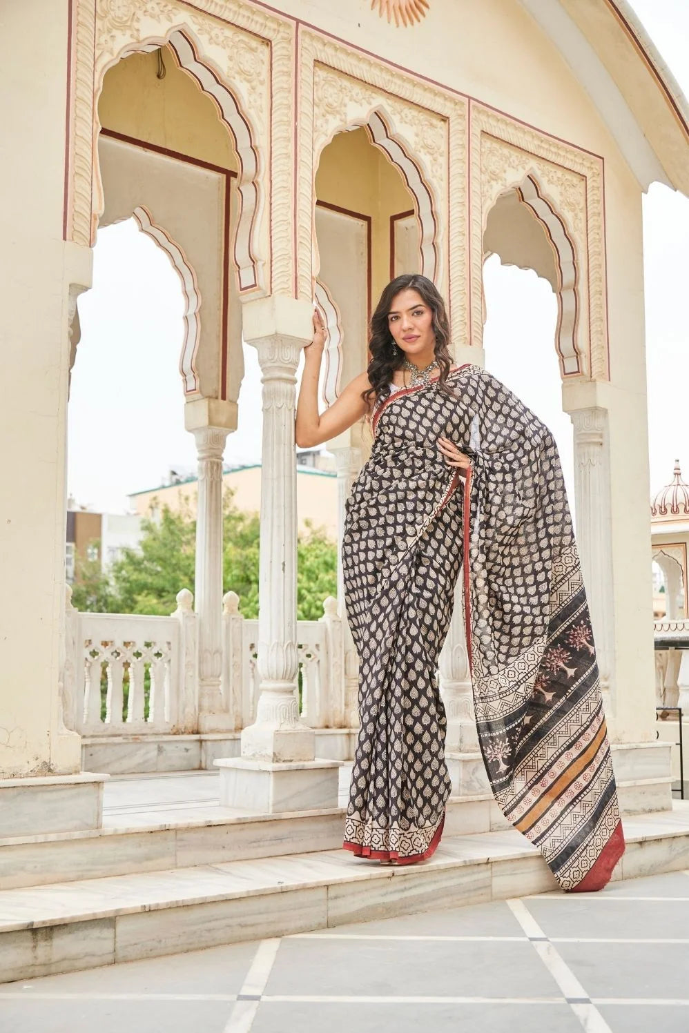 Black mulmul cotton saree with elegant handcrafted motifs.