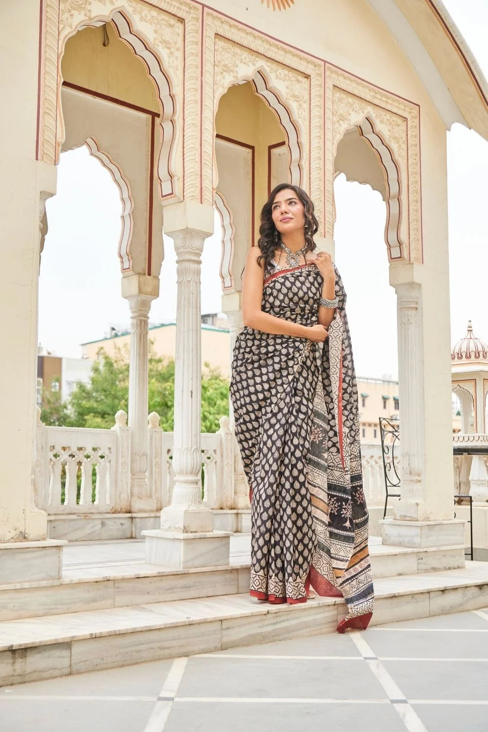 Black mulmul cotton saree with elegant handcrafted motifs.