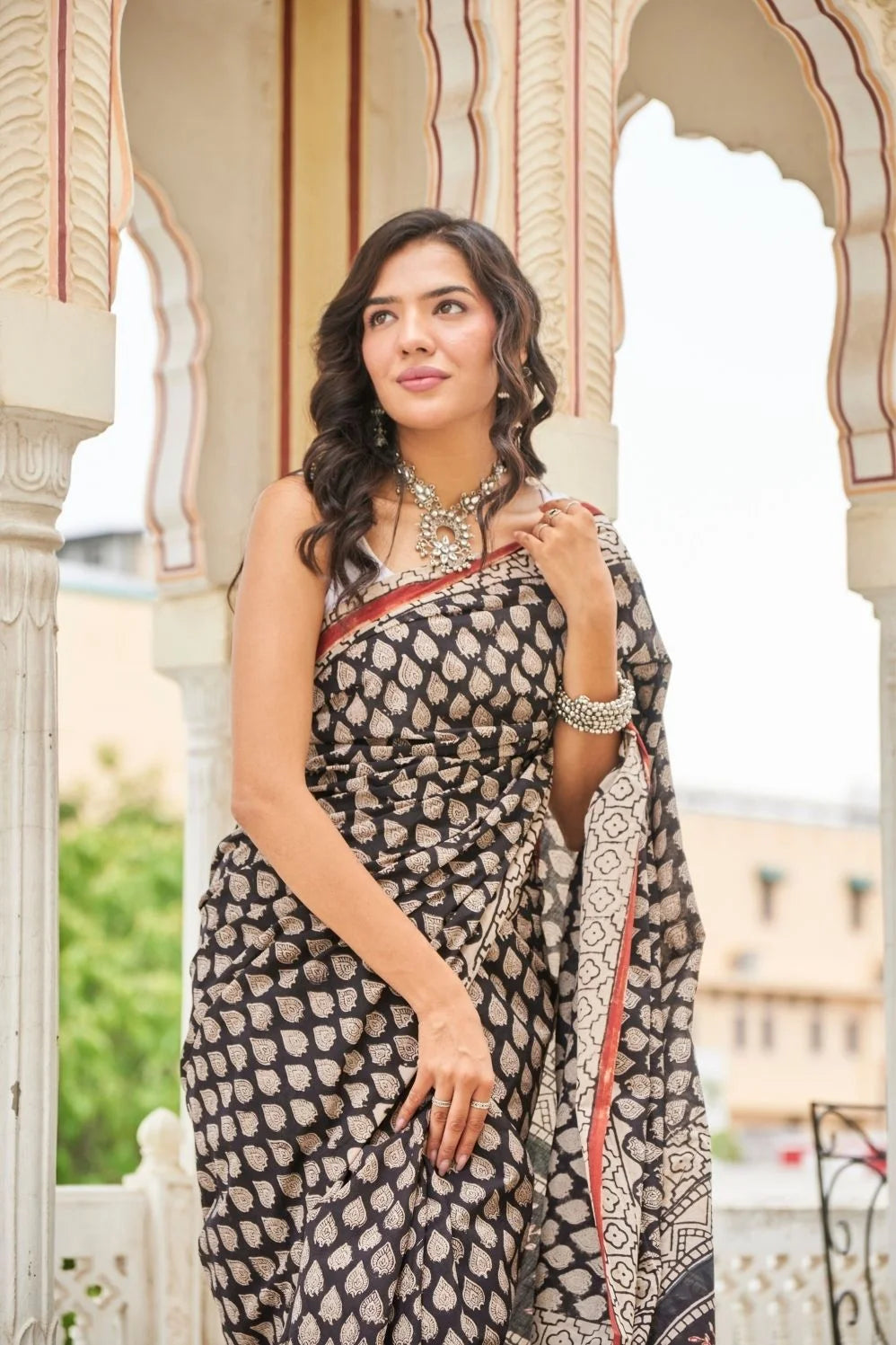 Black mulmul cotton saree with elegant handcrafted motifs.