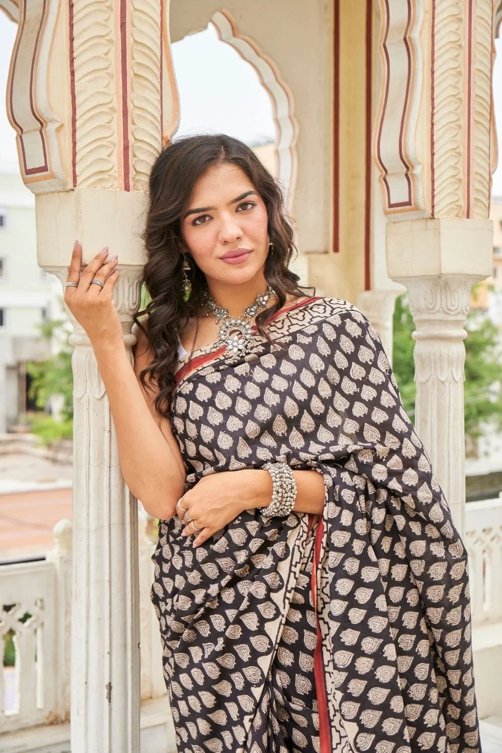 Black mulmul cotton saree with elegant handcrafted motifs.