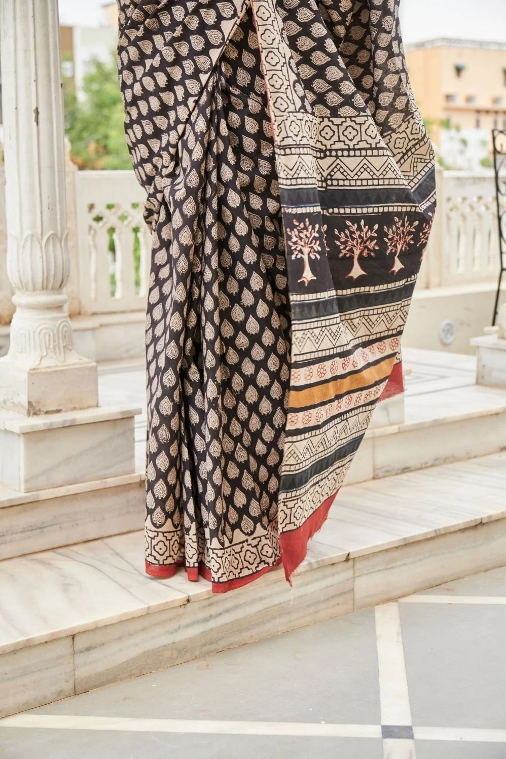 Black mulmul cotton saree with elegant handcrafted motifs.