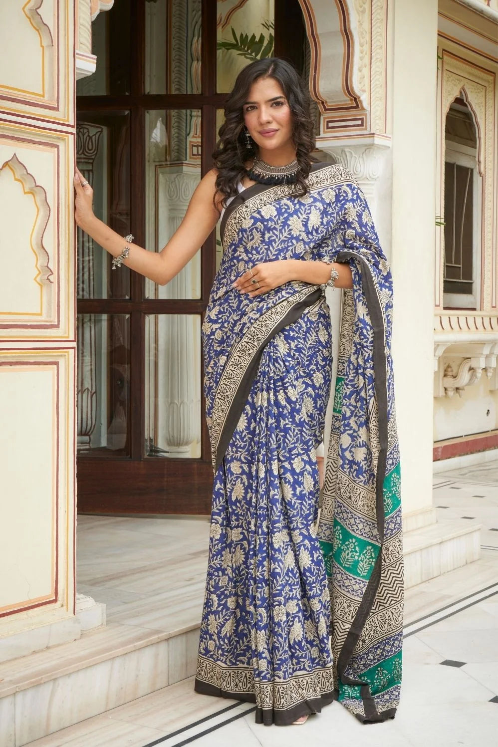 Blue and green mulmul cotton saree with detailed hand block print.