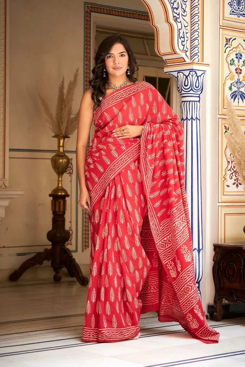 Bright red mulmul cotton saree with handcrafted block prints.