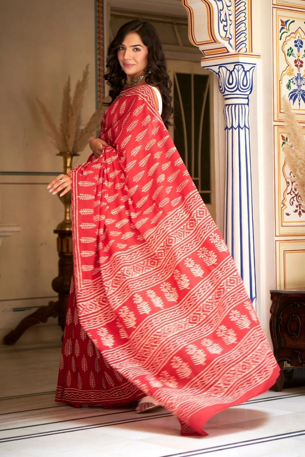 Bright red mulmul cotton saree with handcrafted block prints.