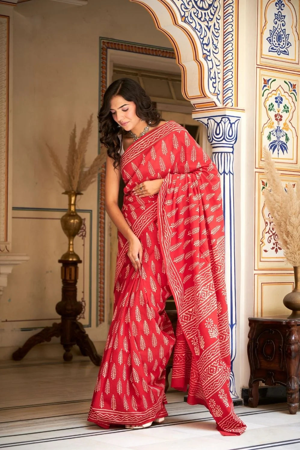 Bright red mulmul cotton saree with handcrafted block prints.