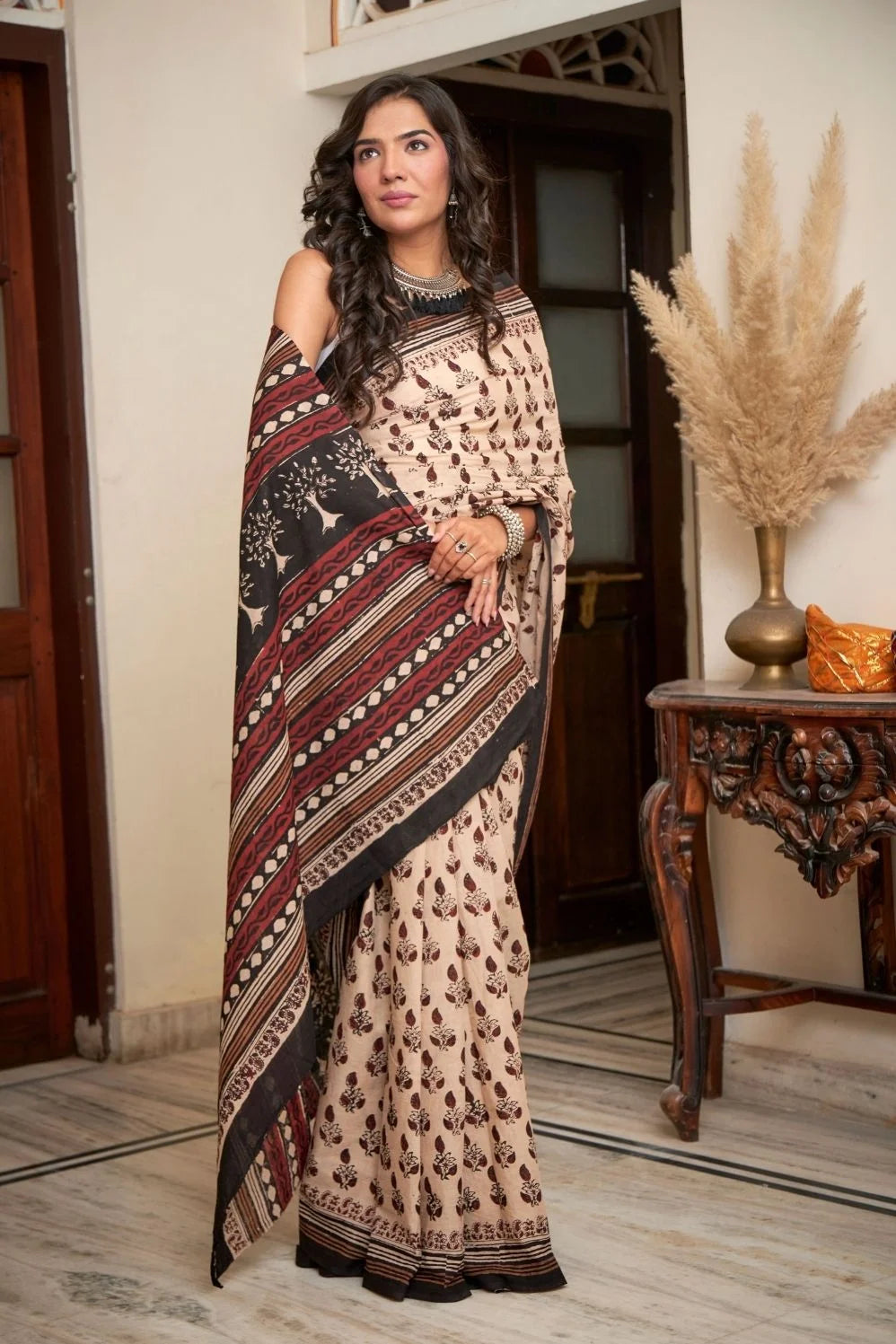 Cream mulmul cotton saree with artistic block printing.