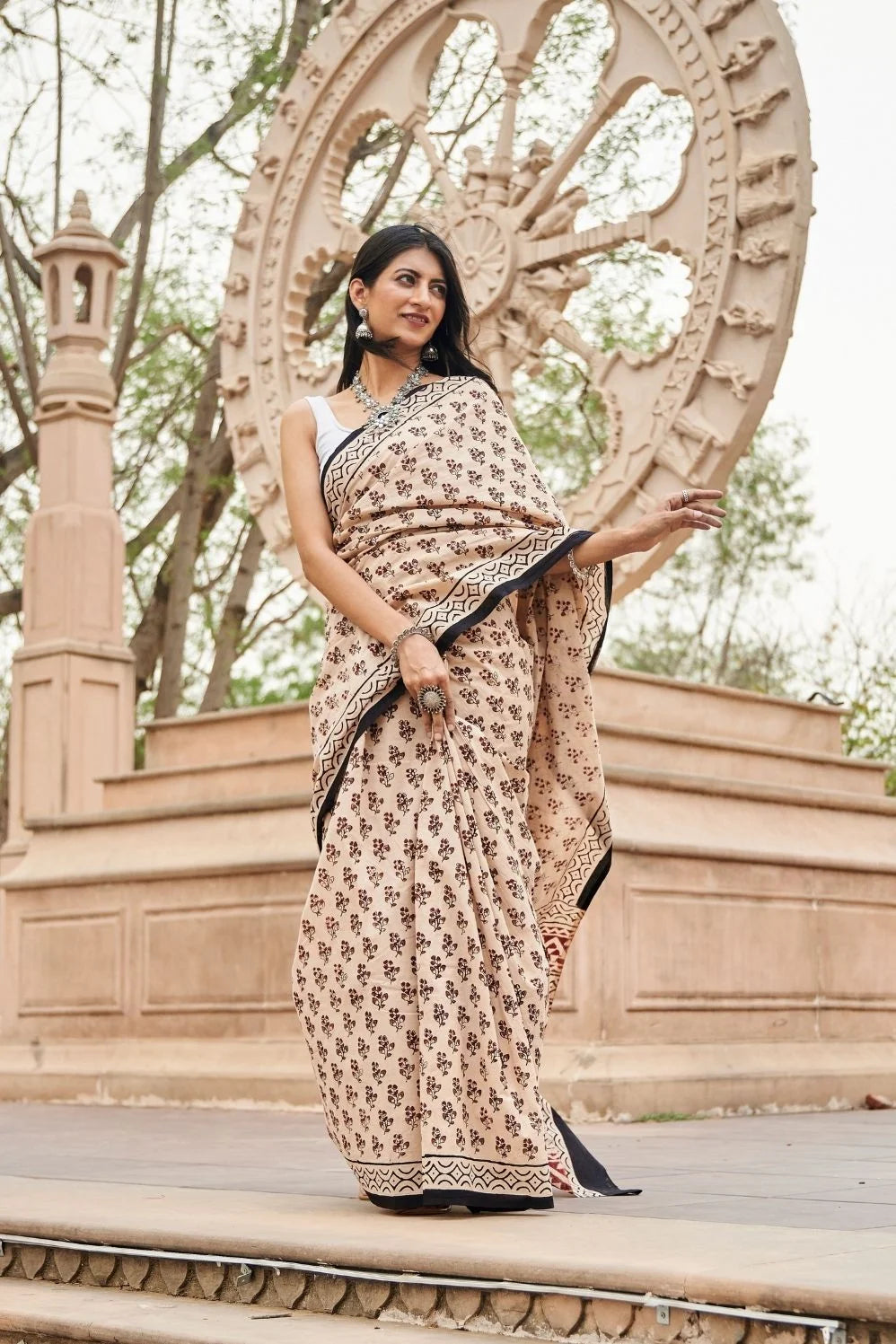 Cream Red mulmul cotton saree with artistic block printing.