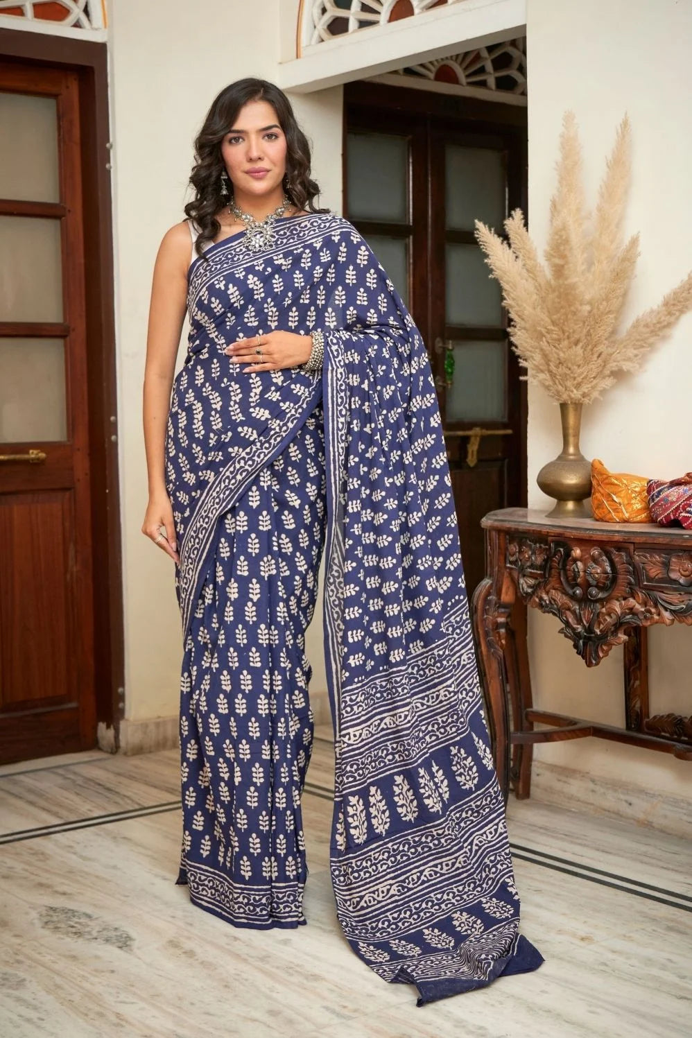 Dark blue mulmul cotton saree with intricate block prints.