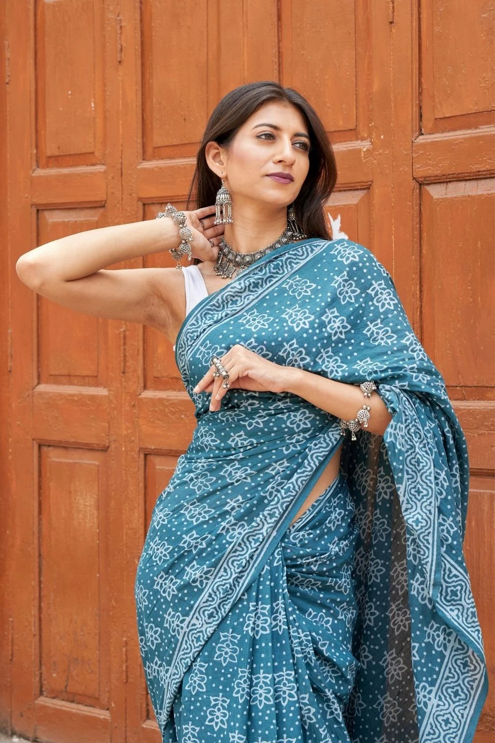 Green mulmul cotton saree with stunning hand block designs.