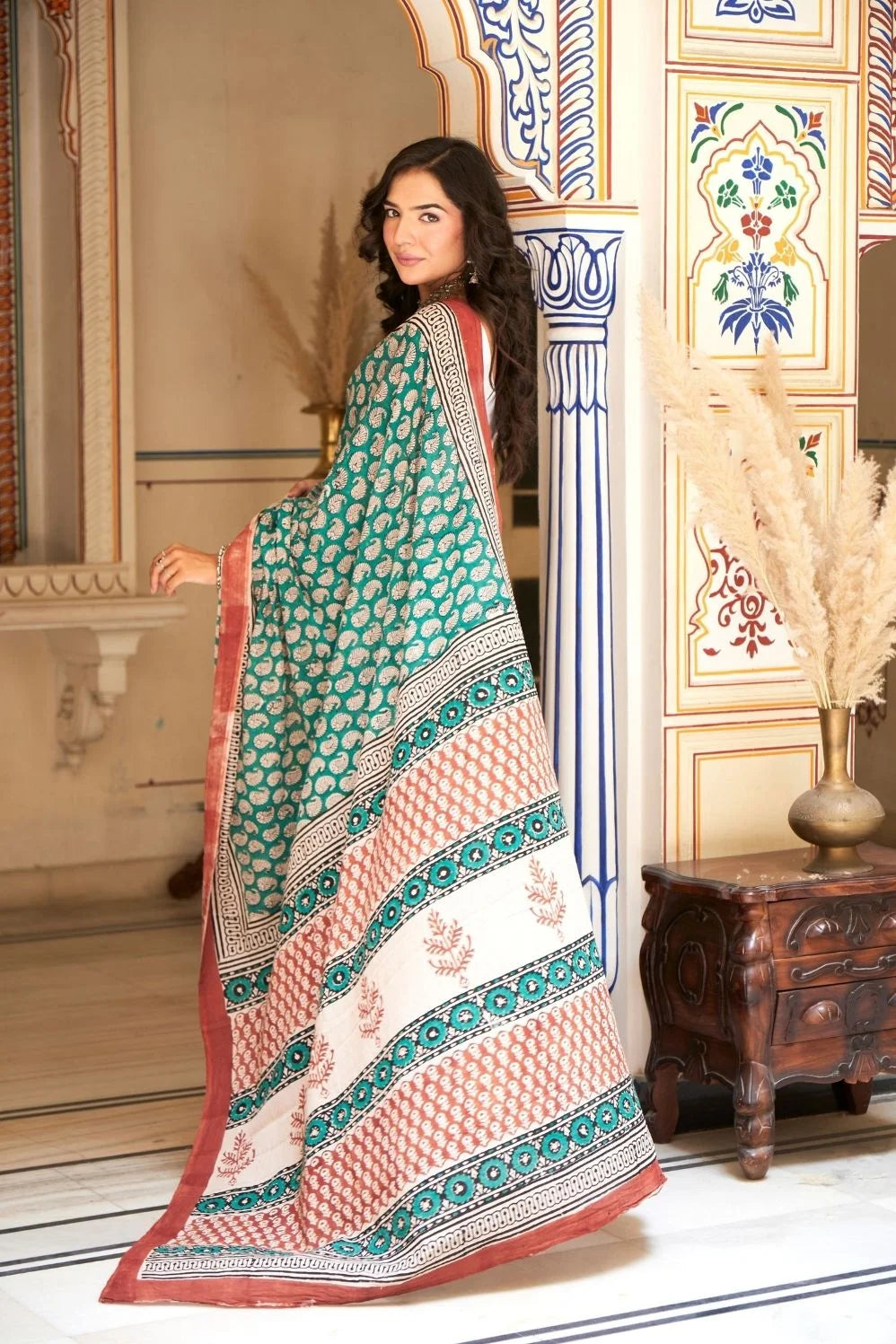 Green mulmul cotton saree with stunning hand block designs.