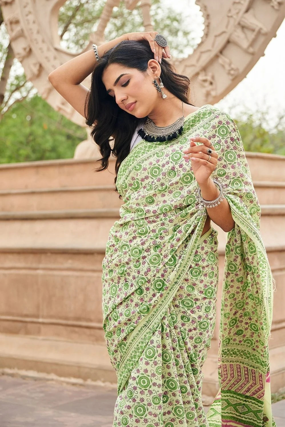 Light green mulmul cotton saree with detailed hand block motifs.