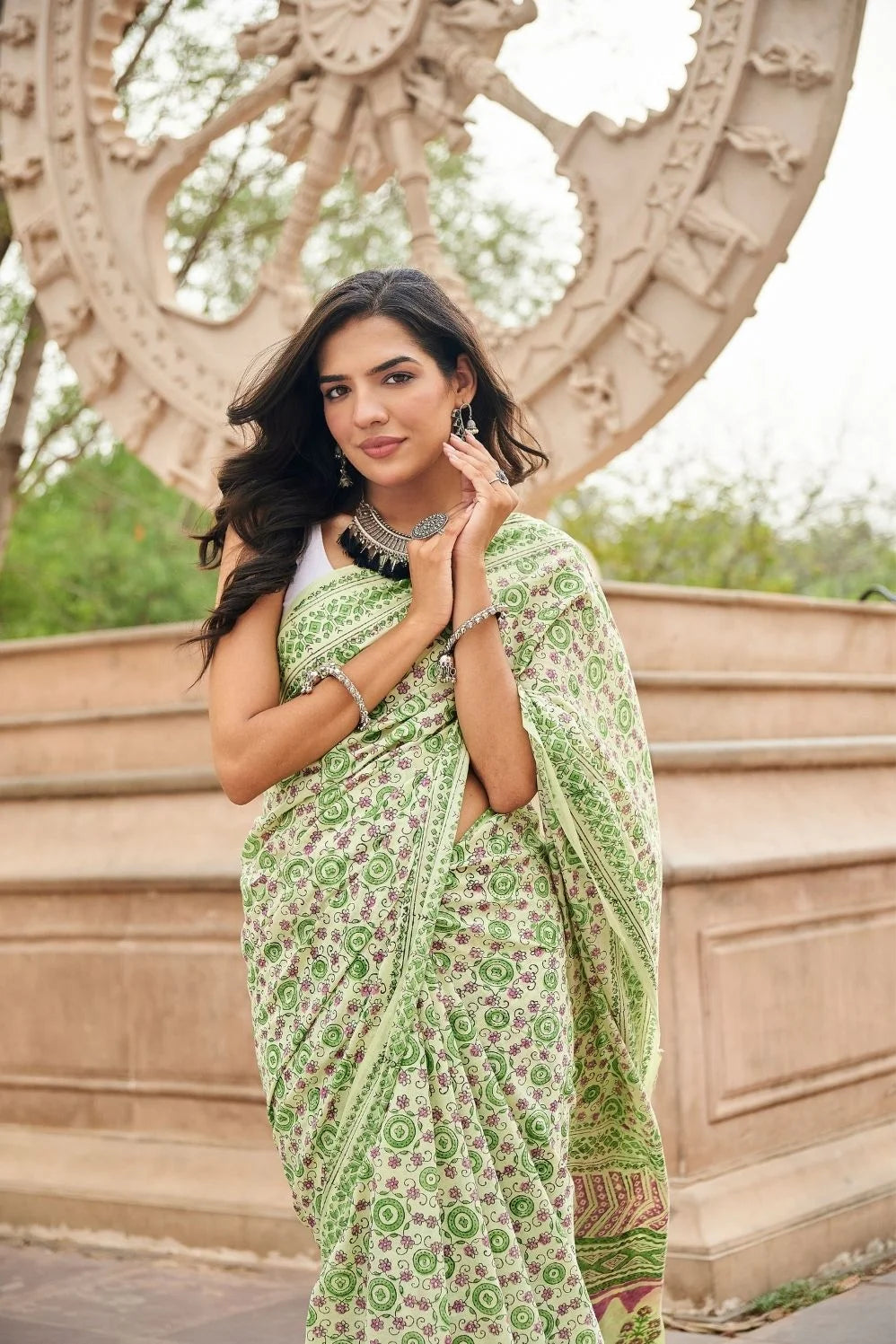 Light green mulmul cotton saree with detailed hand block motifs.
