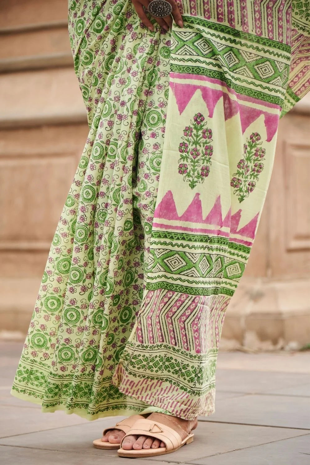 Light green mulmul cotton saree with detailed hand block motifs.