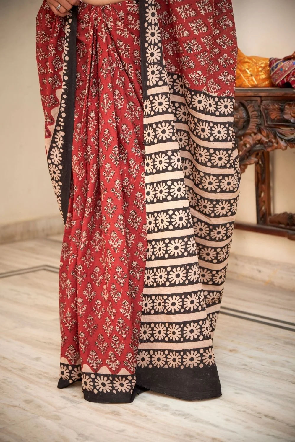 Maroon mulmul cotton saree with intricate hand block patterns.
