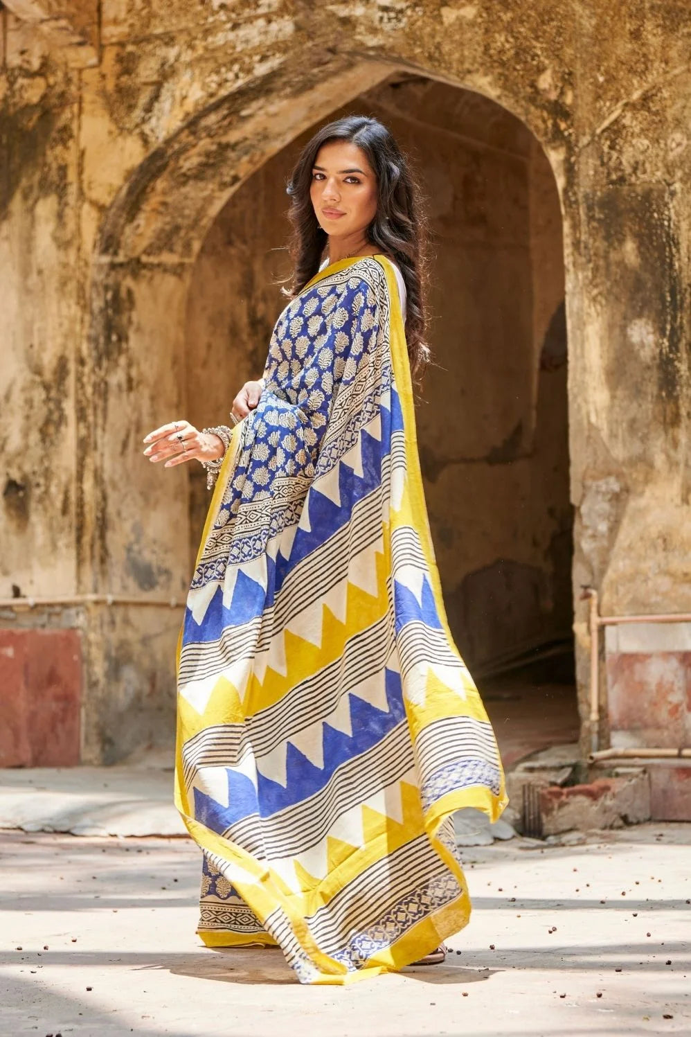 Royal blue and yellow mulmul cotton saree with artistic prints.