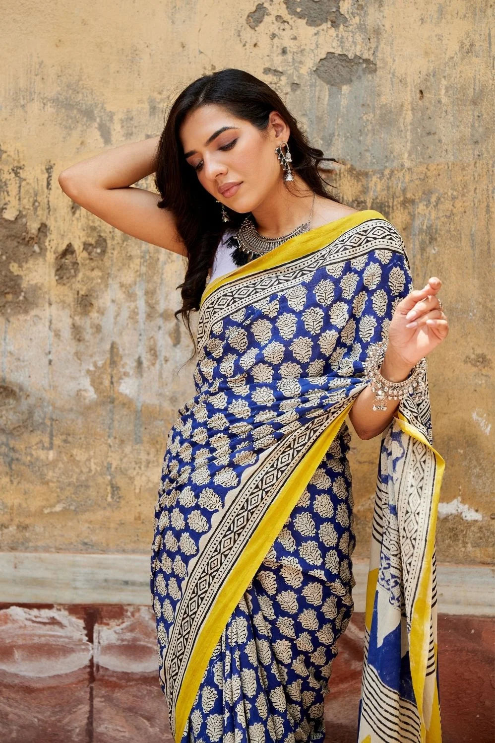 Royal blue and yellow mulmul cotton saree with artistic prints.