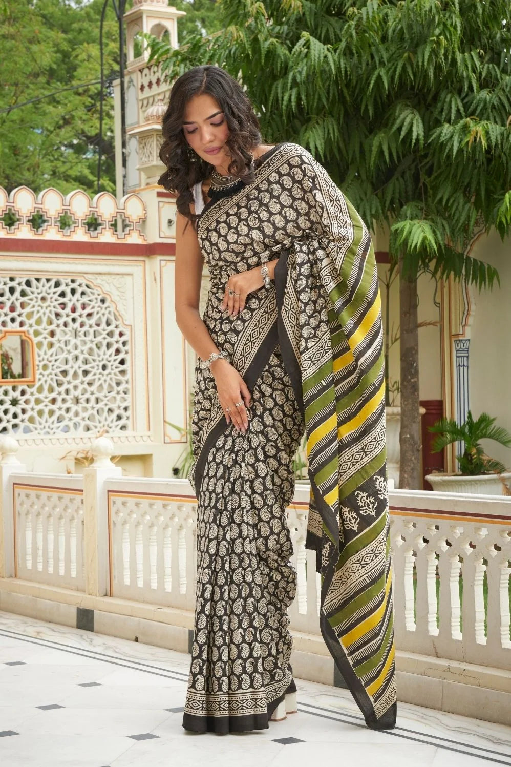 Black mulmul cotton saree with intricate booti print.