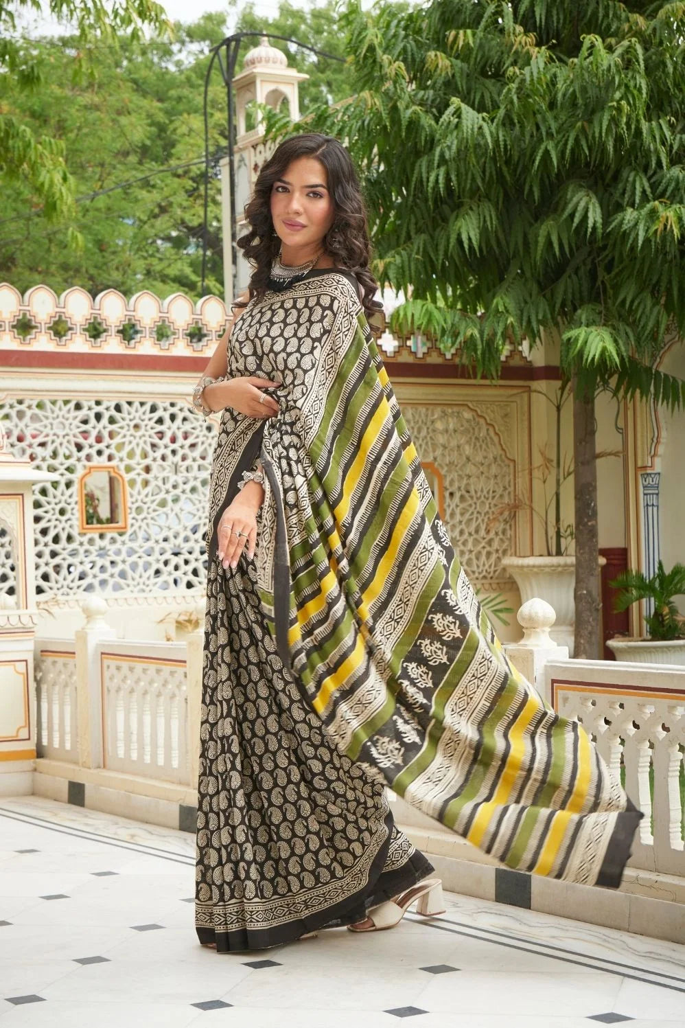 Black mulmul cotton saree with intricate booti print.