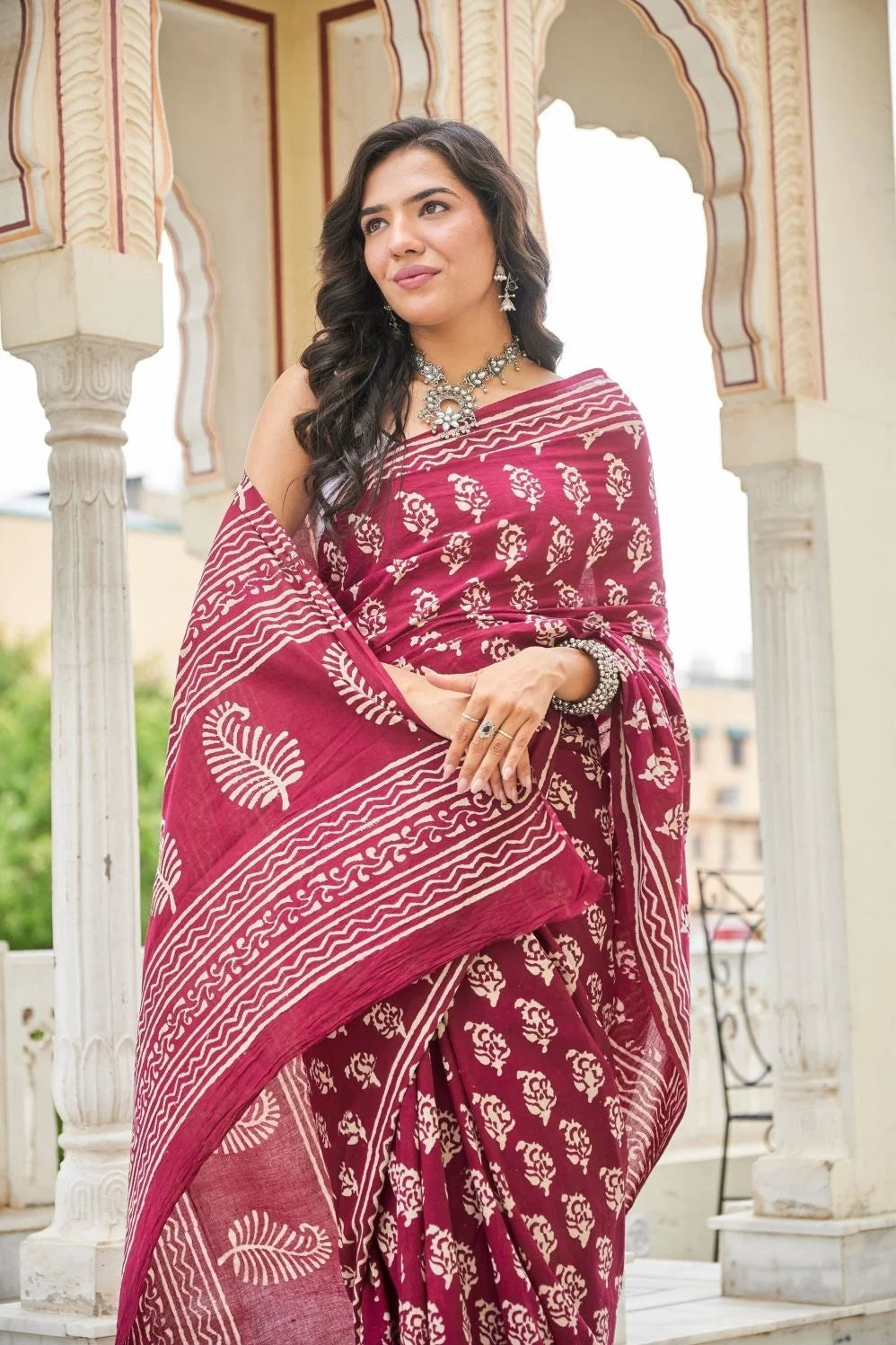 Wine red mulmul cotton saree with delicate hand block work.