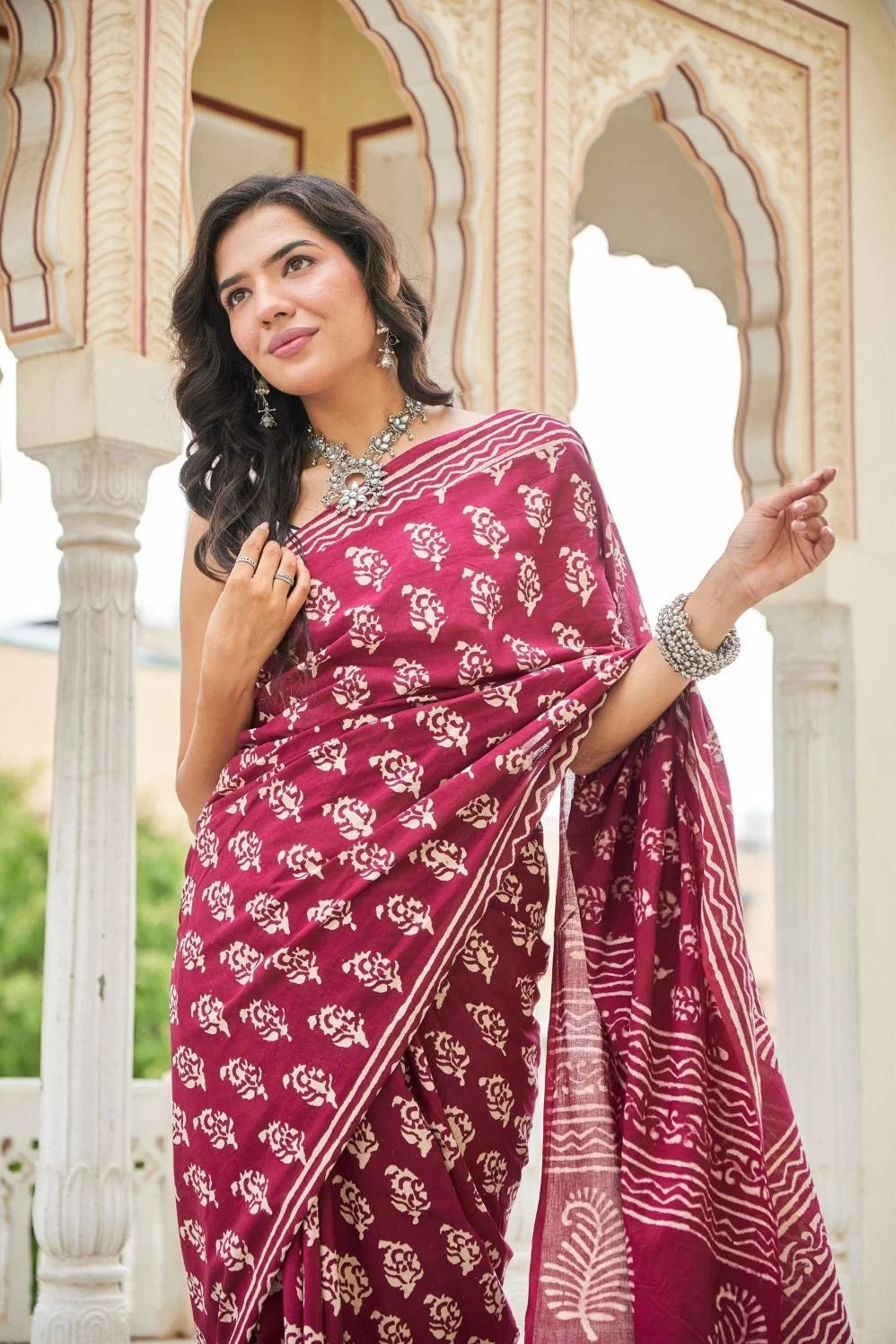 Wine red mulmul cotton saree with delicate hand block work.