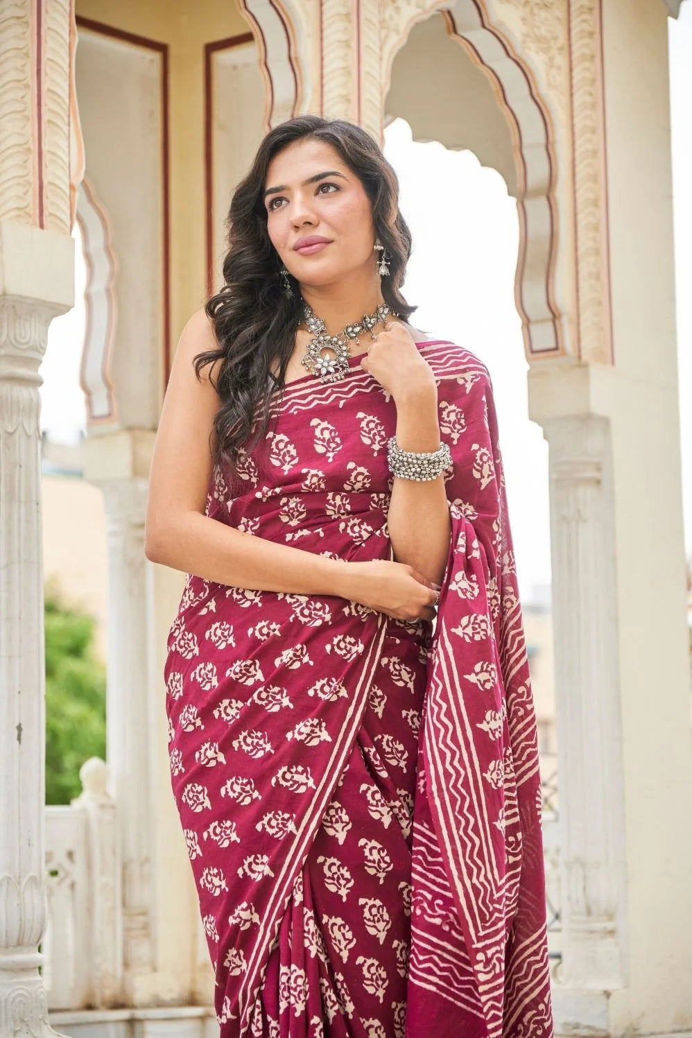 Wine red mulmul cotton saree with delicate hand block work.
