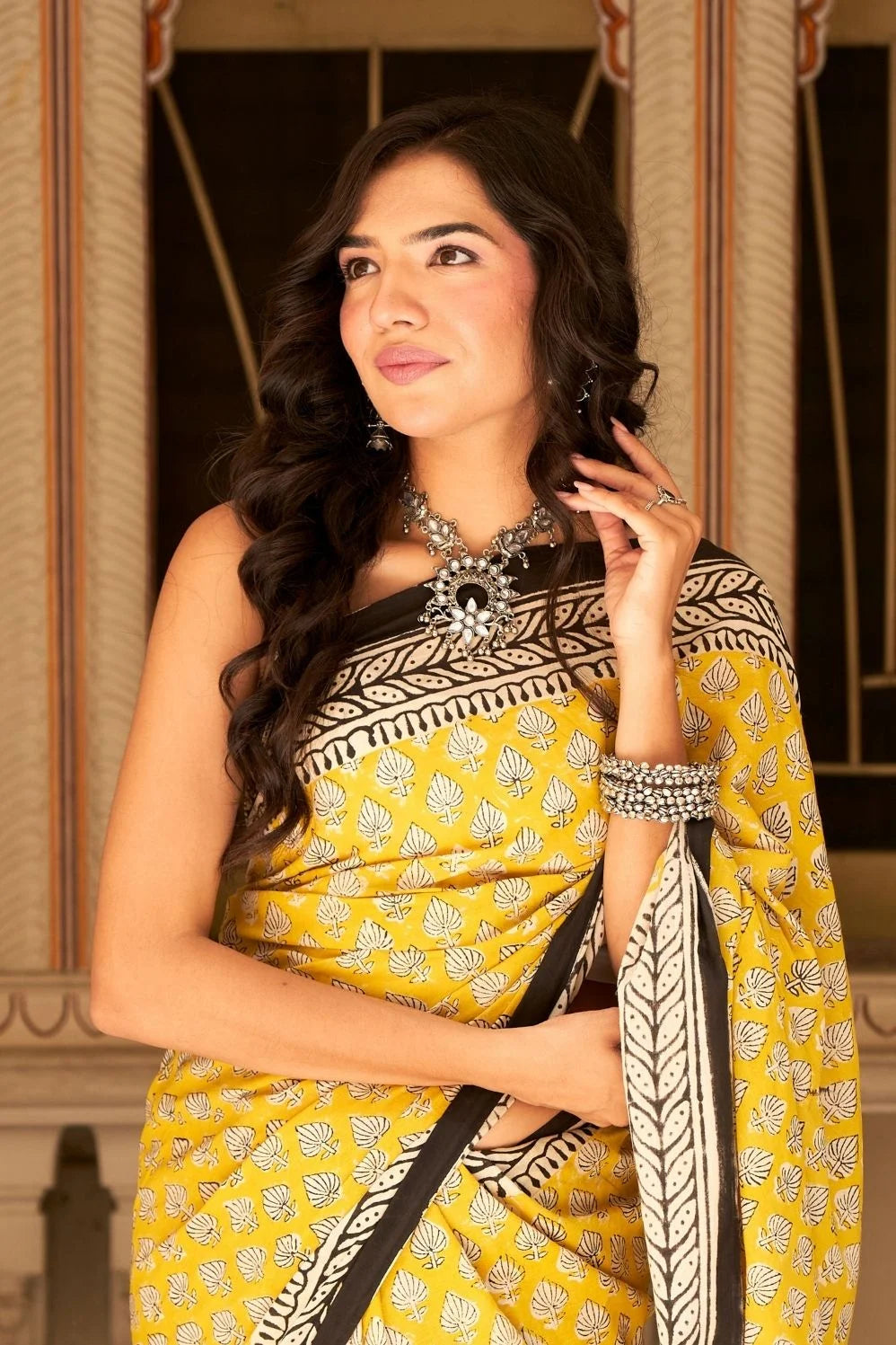 Yellow mulmul cotton saree with traditional hand block prints.