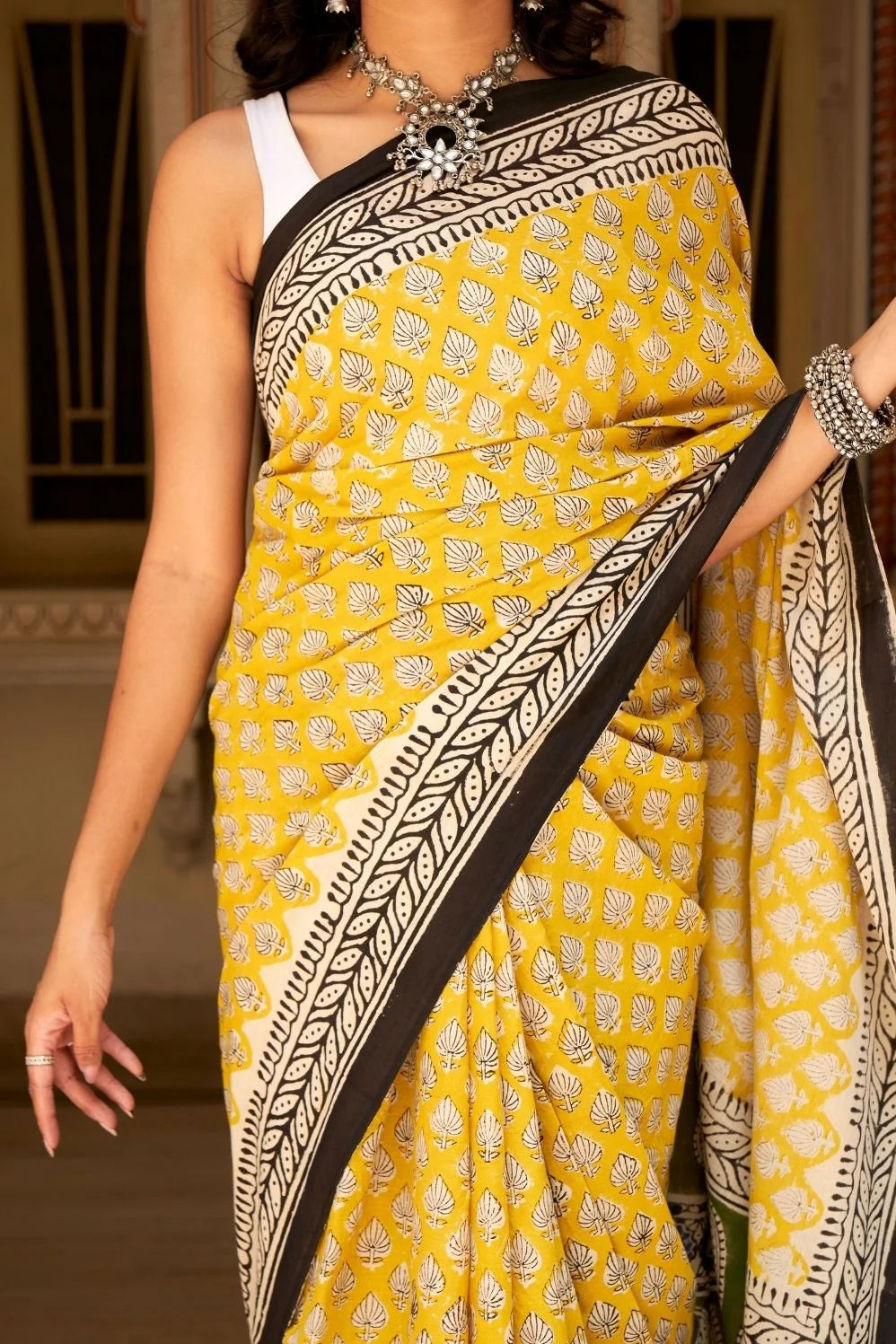 Yellow mulmul cotton saree with traditional hand block prints.