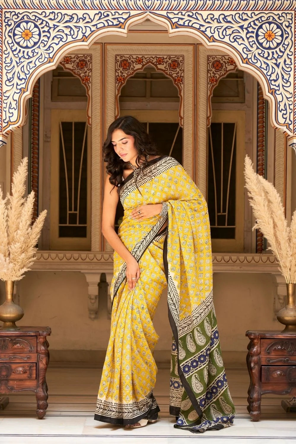 Yellow mulmul cotton saree with traditional hand block prints.