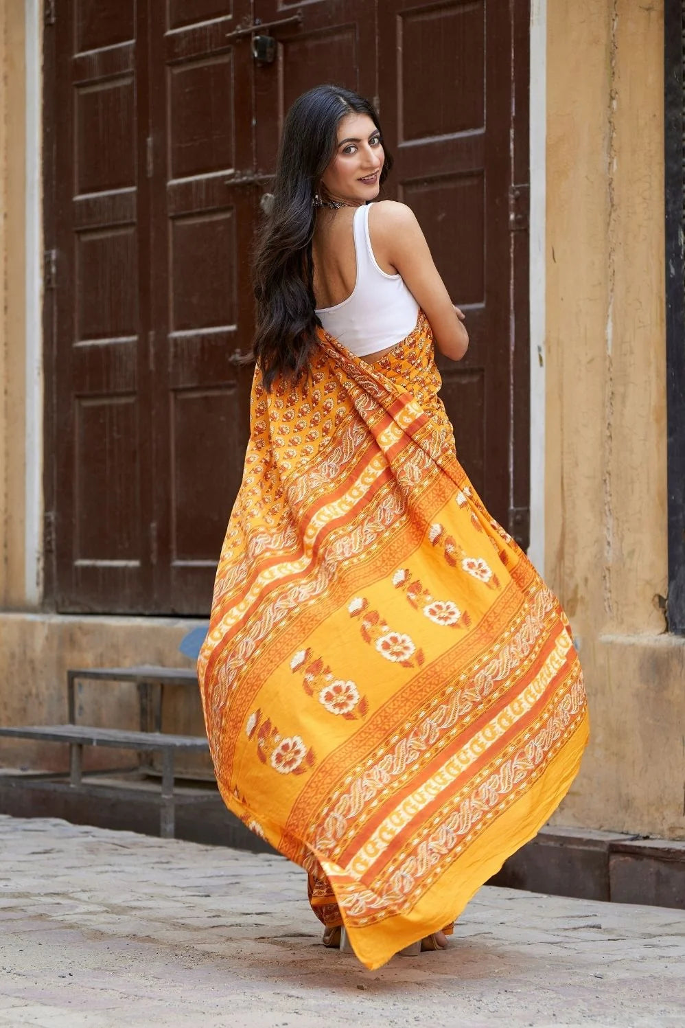 Yellow mulmul cotton saree with traditional hand block prints.