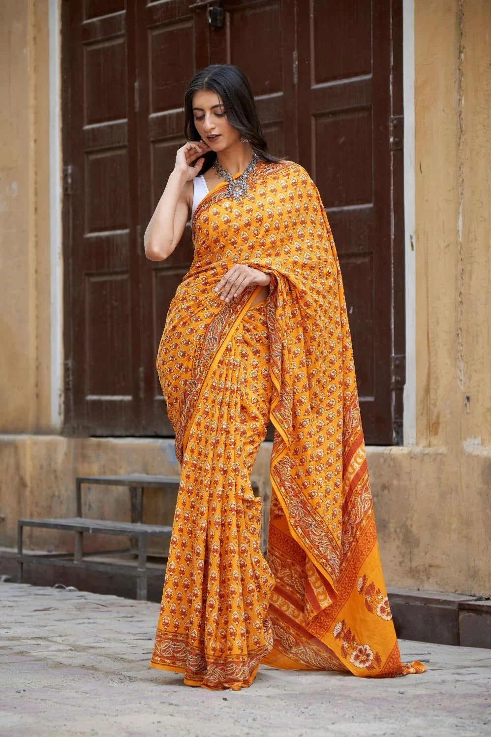 Yellow mulmul cotton saree with traditional hand block prints.
