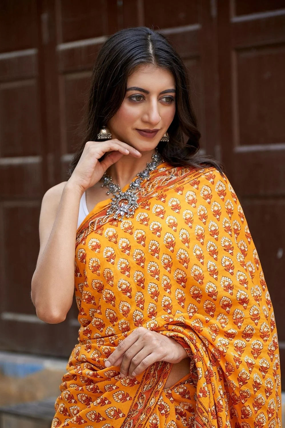 Yellow mulmul cotton saree with traditional hand block prints.