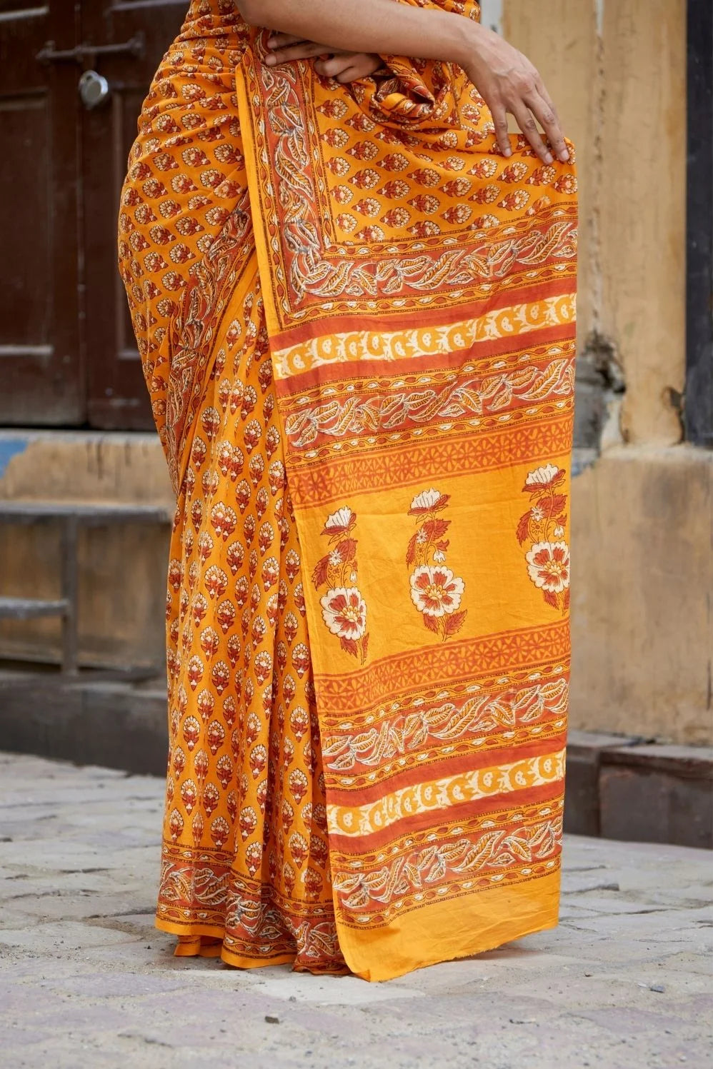Yellow mulmul cotton saree with traditional hand block prints.
