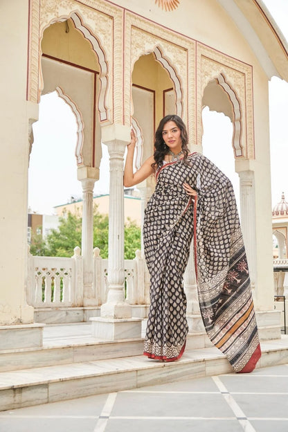 Black mulmul cotton saree with elegant handcrafted motifs.