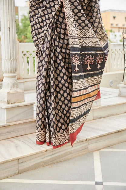 Black mulmul cotton saree with elegant handcrafted motifs.