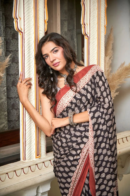 Black mulmul cotton saree with elegant handcrafted motifs.