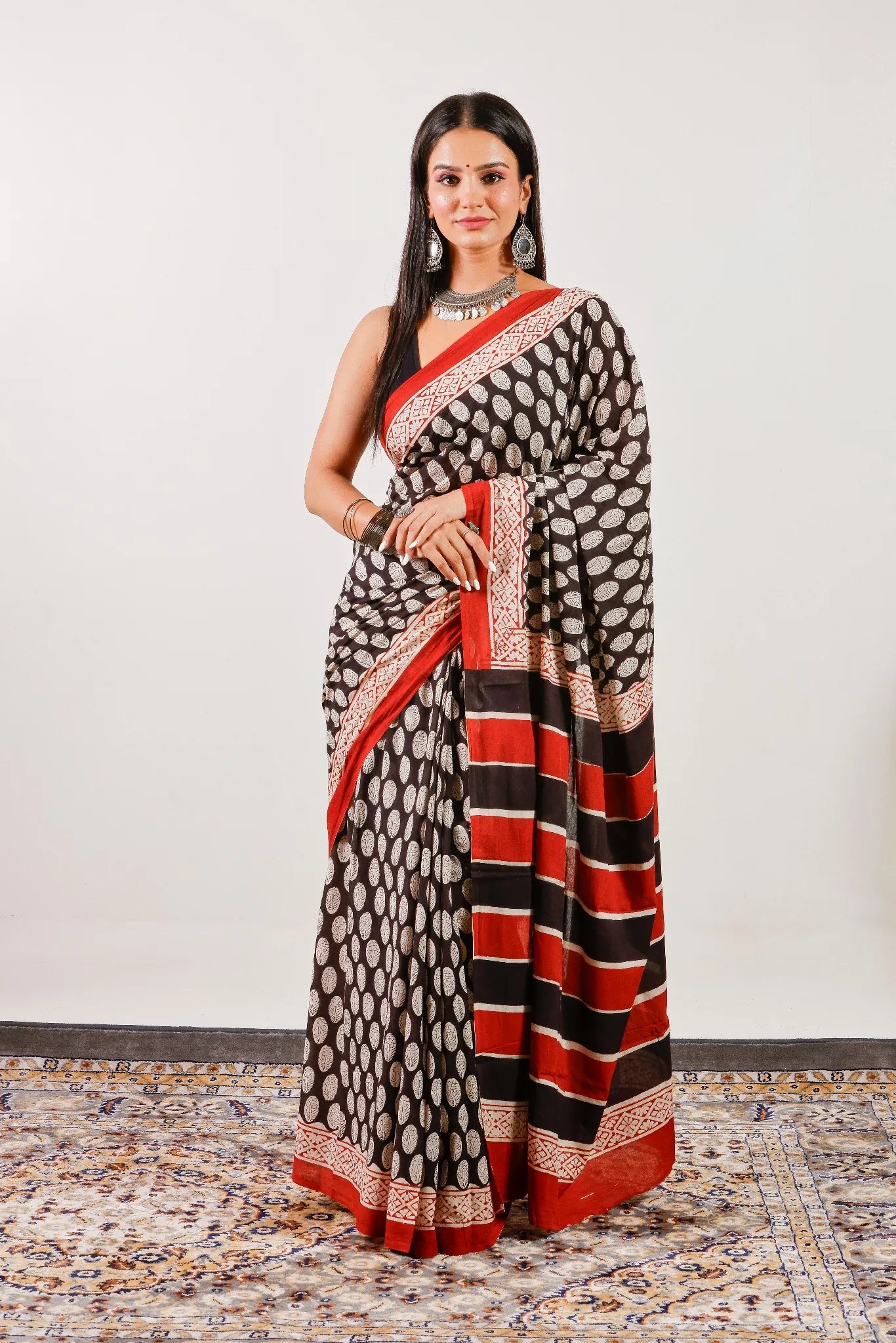 Lightweight black mulmul cotton saree with traditional hand block print – full-length view.