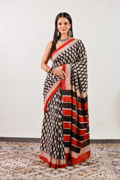 Lightweight black mulmul cotton saree with traditional hand block print – full-length view.
