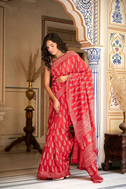 Bright red mulmul cotton saree with handcrafted block prints.