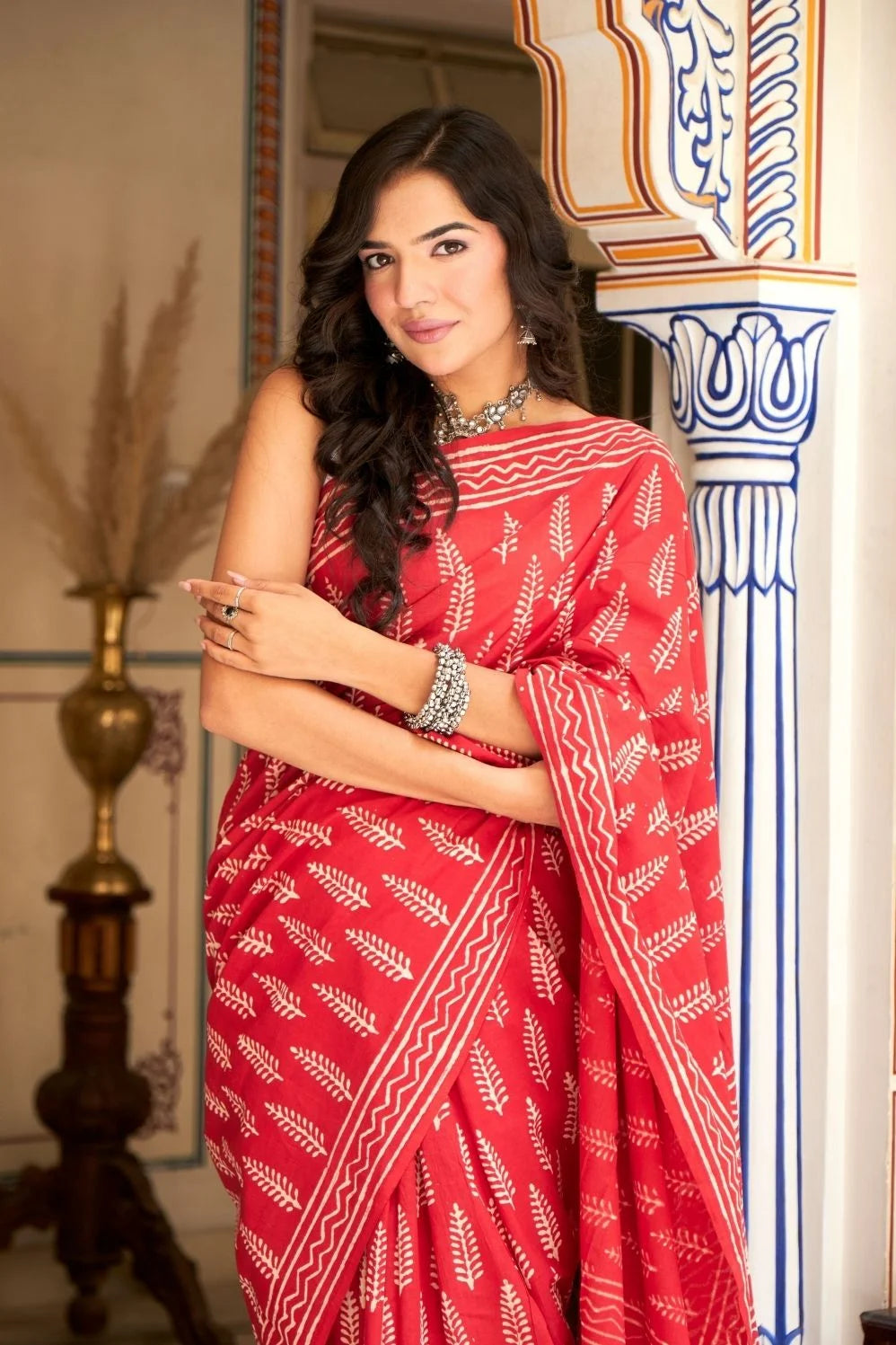 Bright red mulmul cotton saree with handcrafted block prints.