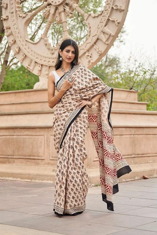 Cream Red mulmul cotton saree with artistic block printing.