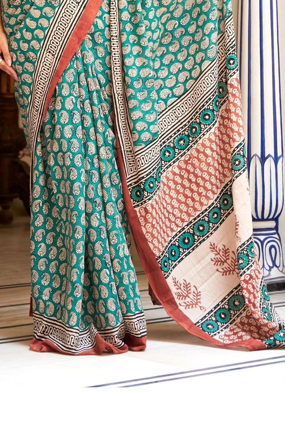 Green mulmul cotton saree with stunning hand block designs.