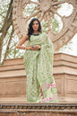 Light green mulmul cotton saree with detailed hand block motifs.