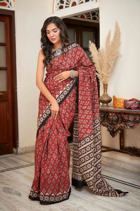 Maroon mulmul cotton saree with intricate hand block patterns.