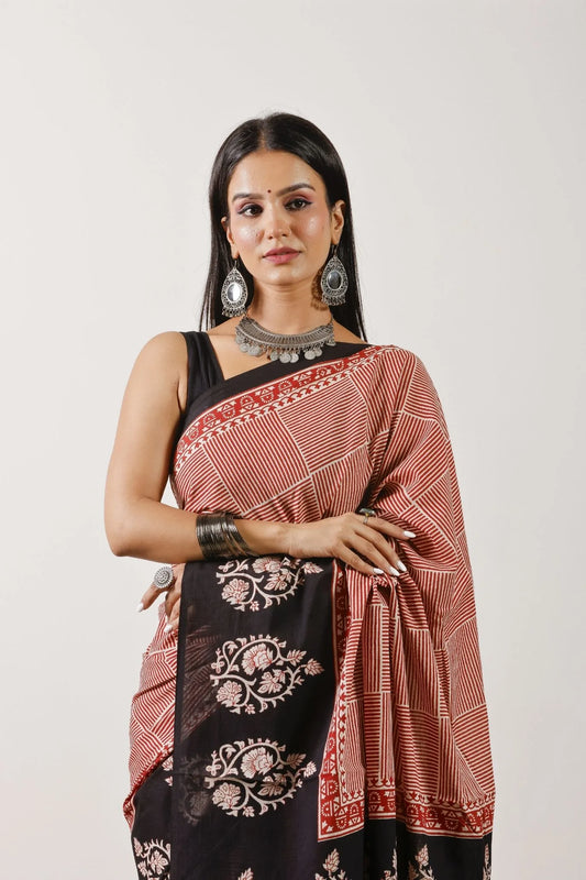 Woman wearing a traditional saree with a white background