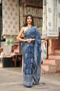Teal cotton saree with exquisite block print patterns.