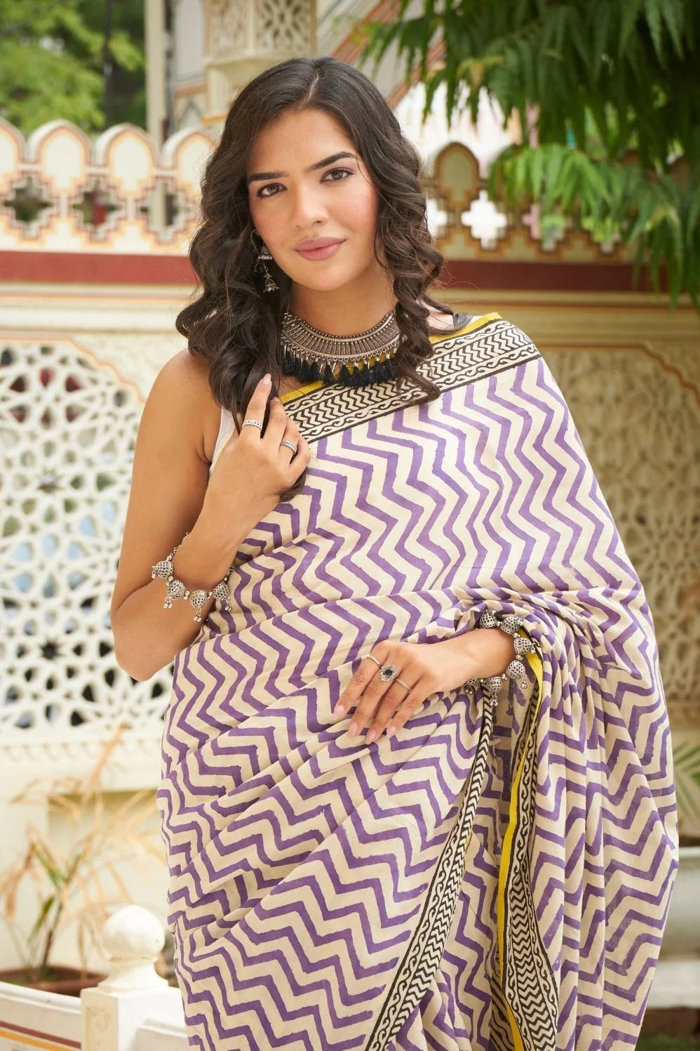 White and purple mulmul cotton saree with artistic block prints.
